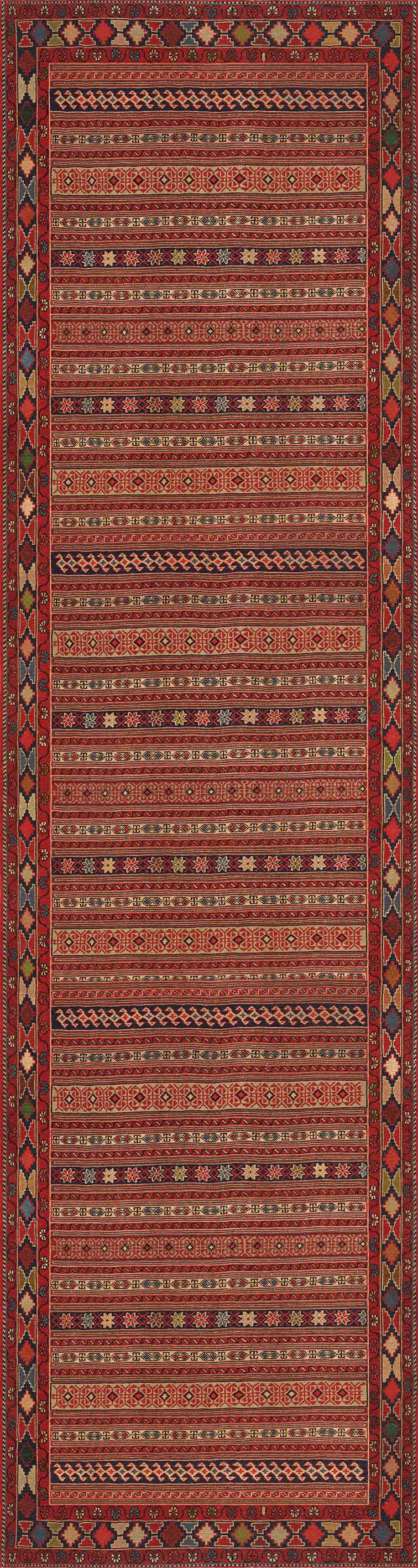 The Majestic Loom - Washable Rug - JRN1003 features intricate geometric patterns and horizontal stripes in red, yellow, black, and white with repeating diamond and zigzag motifs, framed by decorative borders for stylish convenience.