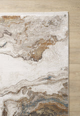 A corner of the Majestic Marble Premium Area Rug - M673M, featuring a marbled abstract design in cream, brown, gray, and blue with a thin fringe, rests on a light wood floor.