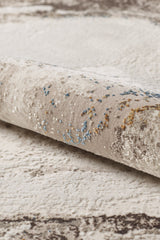 A close-up of the Majestic Marble Premium Area Rug - M673M, featuring a plush acrylic-viscose blend with a cream base and abstract blue, gold, and brown patterns. The textured pile and soft fibers are clearly visible.