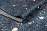 A close-up of the Midnight Majesty - Machine-Washable Rug (JRS5052, Custom Size) in dark blue, featuring a folded corner that highlights its textured surface and intricate white and light brown geometric patterns—ideal for high-traffic areas.