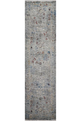 The Miniature Elegance Oushak Rug - Grey - 2084F is a narrow, rectangular machine-made rug with a vintage look, featuring a faded distressed design and delicate floral and geometric patterns in blue, gray, and hints of red.