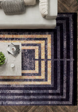 The Minimalist and Clean - Washable Rug - JR1407 (Outlet) US, featuring concentric purple, gold, and beige rectangles, sits under a marble coffee table near a light grey sofa with patterned pillows on dark herringbone wood flooring.