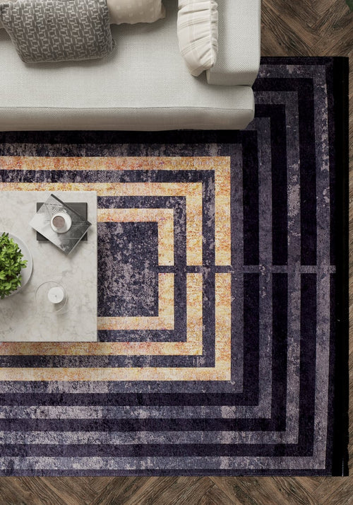 Load image 1 in gallery view. Modern living room with a white sofa, Minimalist and Clean - Washable Rug - JR1407 (Custom Size) in concentric purple and gold rectangles, marble coffee table with plant, candle, books—all on durable herringbone flooring.