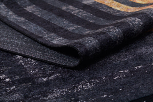 Load image 1 in gallery view. A close-up of the Minimalist and Clean - Washable Rug - JR1407 (Custom Size) reveals its textured striped pattern in gray, black, and gold tones—perfect for high-traffic areas. The rug is slightly folded to show both surface and underside.