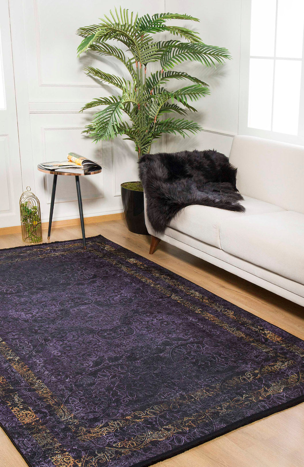 A modern living room with a white sofa, black fur throw, round side table, open book, potted plant, lantern, and the Minimalist and Elegant - Washable Rug - JR1298 (Custom Size)—perfect for high-traffic areas—on a wooden floor.