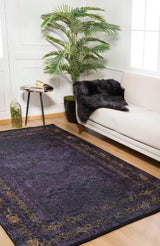 A modern living room with a white sofa, black fur throw, round side table, open book, potted plant, lantern, and the Minimalist and Elegant - Washable Rug - JR1298 (Custom Size)—perfect for high-traffic areas—on a wooden floor.