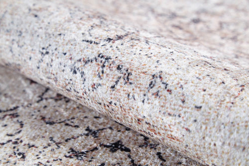 Load image 1 in gallery view. A close-up of the Misty Mosaic - Washable Rug - JR1690 (Custom Size) highlights its cream and beige colors with brown and black speckled patterns, resembling a smooth, marble-like surface.