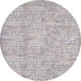 The Modern Enigma - Machine-Washable Rug JR1883 is a round, washable rug with a muted, textured pattern in beige, gray, and blue tones and subtle geometric and tribal designs—ideal for high-traffic areas.