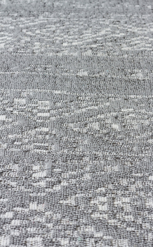 Load image 1 in gallery view. Close-up of Modern Mist - Washable Double-Sided Kilims - AR01: a textured gray woven fabric with a subtle geometric pattern, featuring varied surfaces of small raised and flat areas for a modern look.