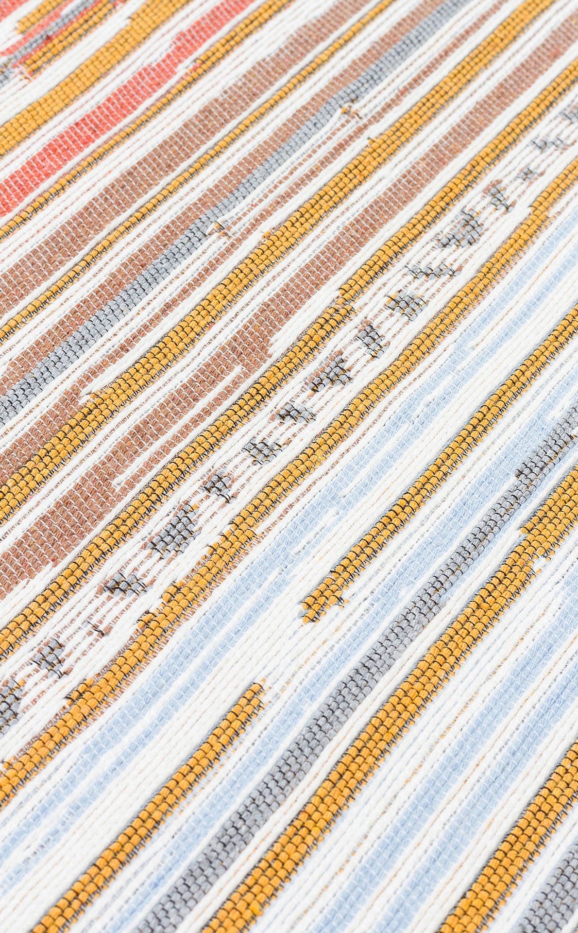A close-up of Mosaic Fade - Washable Reversible Kilims - AR35 displays a woven textile with horizontal white, yellow, blue, brown, and orange stripes, showcasing uneven threads and a textured surface.