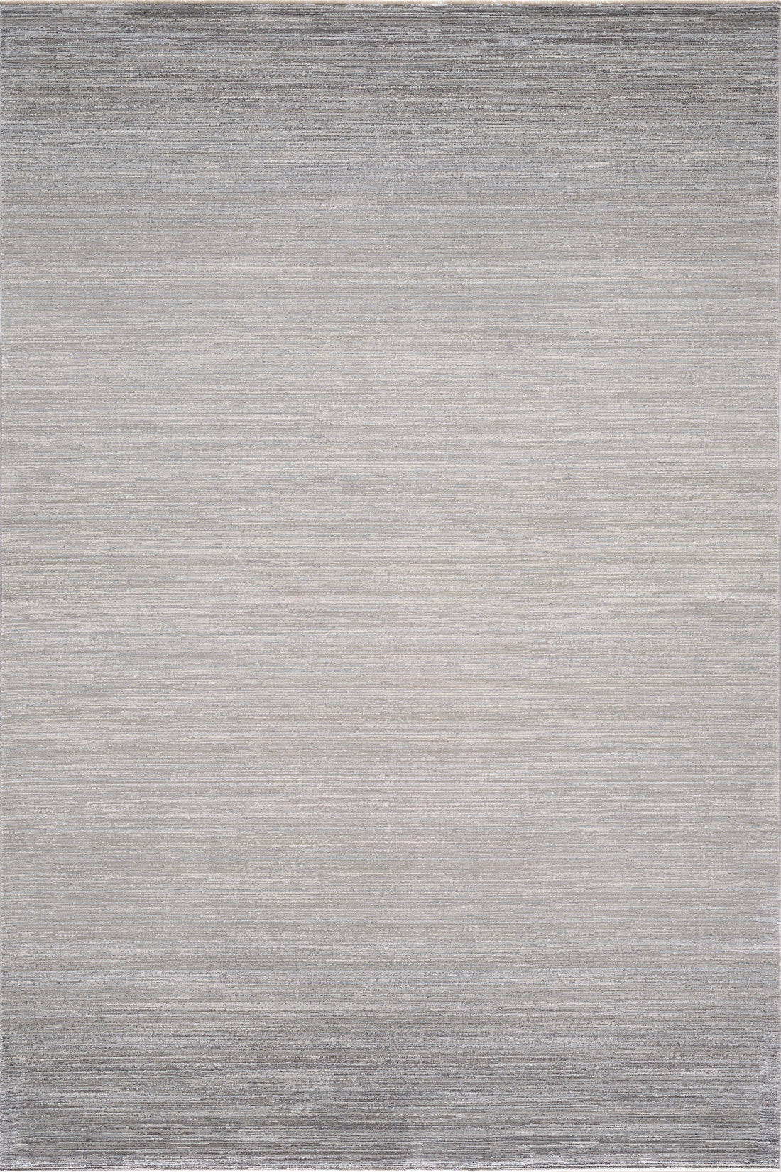 The Muted Palette Grey Ombre Rug - EW2636 is a modern, machine-made rug in neutral tones, showcasing a subtle gradient from light gray center to darker edges with a soft, textured weave.