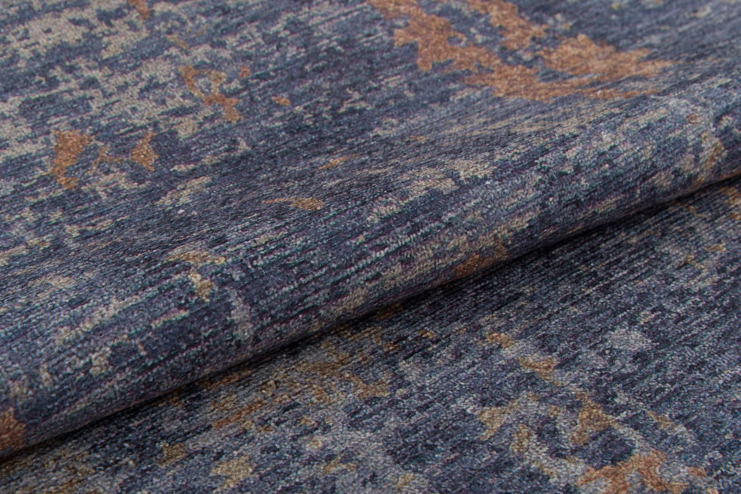 A close-up of the Mystical Mosaic - Washable Rug - JRS003 (Custom Size) shows its folded, textured fabric with a blue, gray, and tan mottled pattern. This washable rug’s subtle color and weave variations make it ideal for high-traffic spaces.