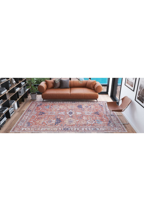 Load image 1 in gallery view. A modern living room with a brown leather sofa, a Mystral Kilim-Design Coral Washable Rug - LCC3015 (Custom Size) ideal for high-traffic areas, a tan minimalist chair, bookshelves, a potted plant, and large windows with natural light.