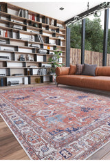 A modern living room featuring the Mystral Kilim-Design Coral Washable Rug - LCC3015 (Custom Size), perfect for high-traffic areas, with a brown leather sofa, open wooden shelves, large windows, and views of green trees outside.