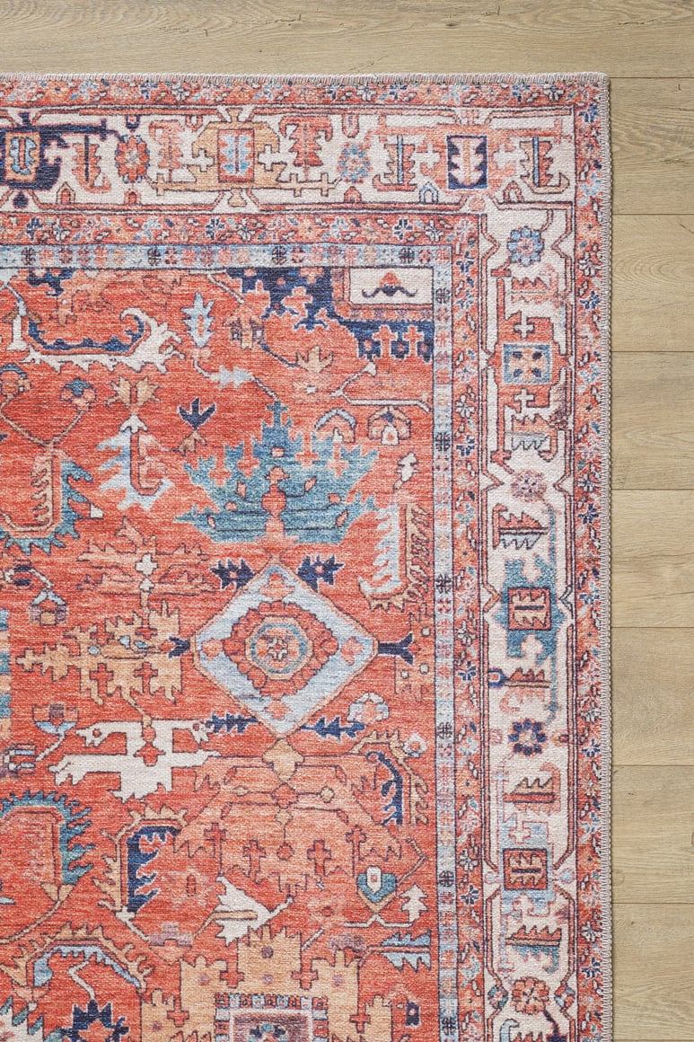 The Mystral Kilim-Design Coral Washable Rug - LCC3015 (Custom Size) features a vibrant red color with blue and cream geometric and floral motifs, making it a stylish and practical choice for high-traffic areas.