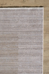 A close-up of the Neutral Frame Modern Bordered Rug - EW5541 shows its textured, light beige surface and fringe edges, elegantly placed on a light wood floor.