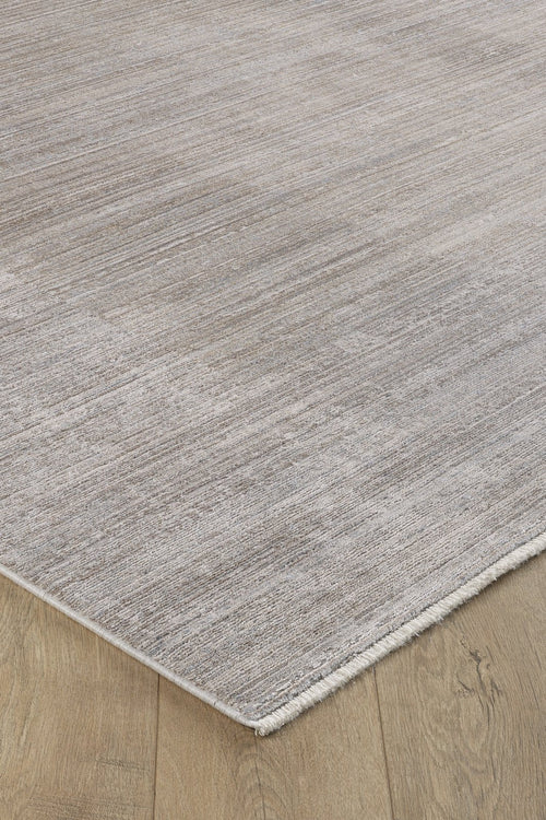 Load image 1 in gallery view. A close-up of the Neutral Frame Modern Bordered Rug - EW5541, featuring a minimalist light grey texture and fringed edges, displayed on a wooden floor with a natural oak finish.
