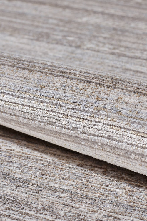 Load image 1 in gallery view. A close-up of the Neutral Frame Modern Bordered Rug - EW5541 shows its soft, slightly shiny surface and rolled, textured design with striped beige, gray, and cream tones.