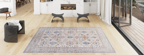 Bild 1 in Galerieansicht laden. A bright, modern living room with light wood floors, a Nexa Bordered Beige Washable Rug - LCC3009 (Custom Size), a black woven chair, curved gray stools, a fireplace, and large windows—ideal for high-traffic areas.