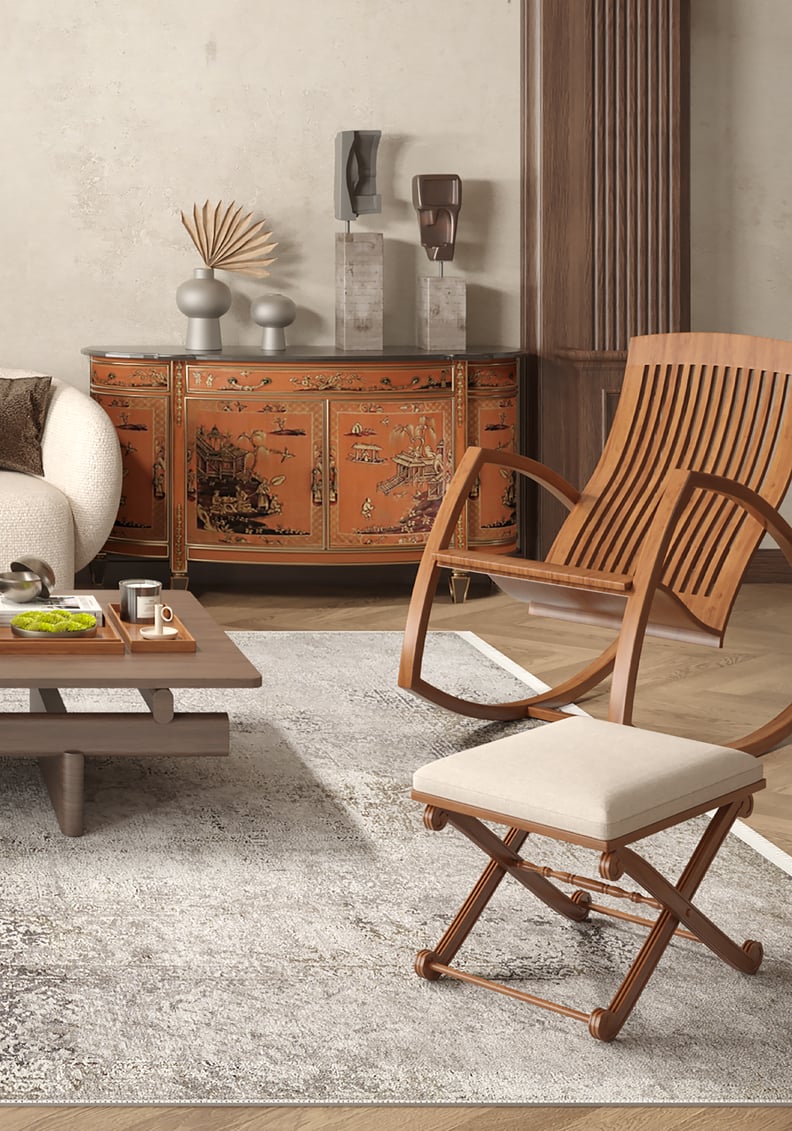 A modern living room features a beige sofa, wooden coffee table with tea set, curved chair with white cushion, and ornate orange sideboard. The Noble Insignia - Washable Rug - JR1830 (Custom Size) adds warmth and suits high-traffic areas.