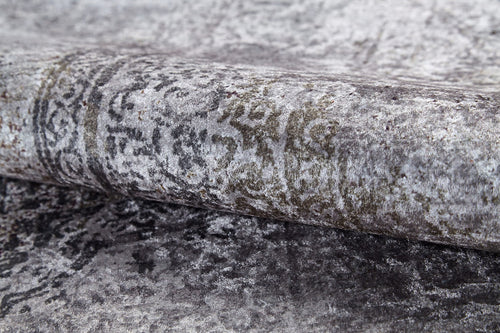 Load image 1 in gallery view. A close-up of the Noble Insignia - Washable Rug - JR1830 (Custom Size) shows its rolled, textured gray surface with a faded, intricate pattern and subtle shade variations—perfect for high-traffic areas.