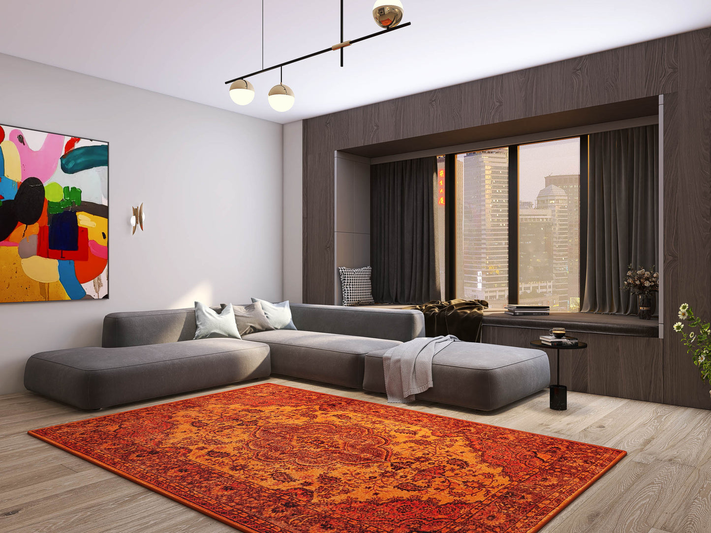 Modern living room with a large gray sectional, colorful abstract art, and the vibrant orange Noble Odyssey - Washable Rug - JRN1012. A floor-to-ceiling window showcases city skyscrapers, complemented by neutral walls and sleek wood flooring.
