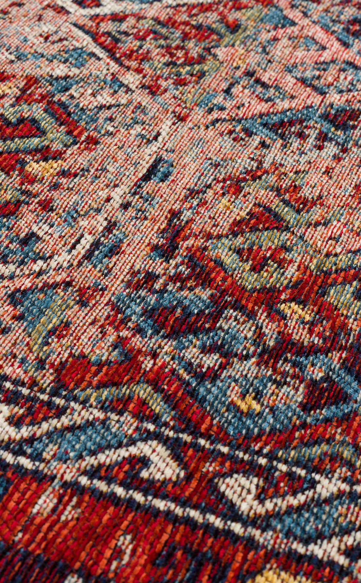 Close-up of Nomad Spirit - Washable Kilims - AND03 reveals its colorful flatwoven texture and intricate patterns in red, blue, green, and beige, highlighting the detailed design of this washable kilim fabric