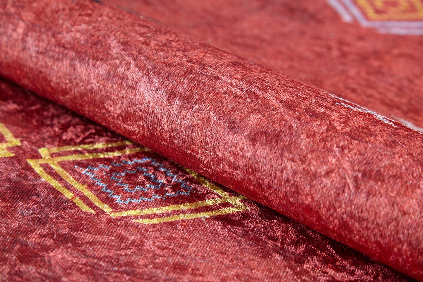 A close-up of the Nomadic Journey - Washable Rug - JR5080 (Custom Size), featuring soft red texture and yellow and blue geometric diamond patterns—ideal for high-traffic areas and easy to clean.