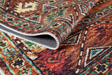 A close-up of the Nomadic Oasis - Washable Rug - JR5086 (Custom Size), featuring intricate geometric patterns in vivid red, orange, green, blue, and cream tones with detailed stitching—ideal for high-traffic areas.