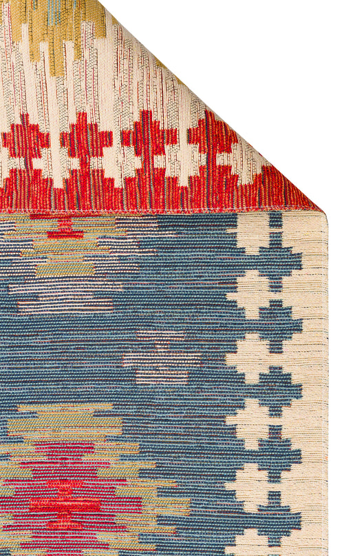 Load image 1 in gallery view. The Ocean Form - Washable Reversible Kilim - NMD04 features blue tribal geometric patterns in red, yellow, and white. A folded top corner reveals the detailed, colorful design of this vibrant and washable rug.