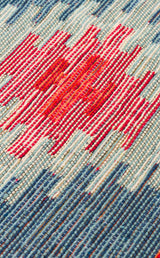 Close-up of the Ocean Form - Kilim - NMD04 rug, highlighting horizontal blue and white stripes with a central red and pink zigzag pattern, and detailed texture in the threads.