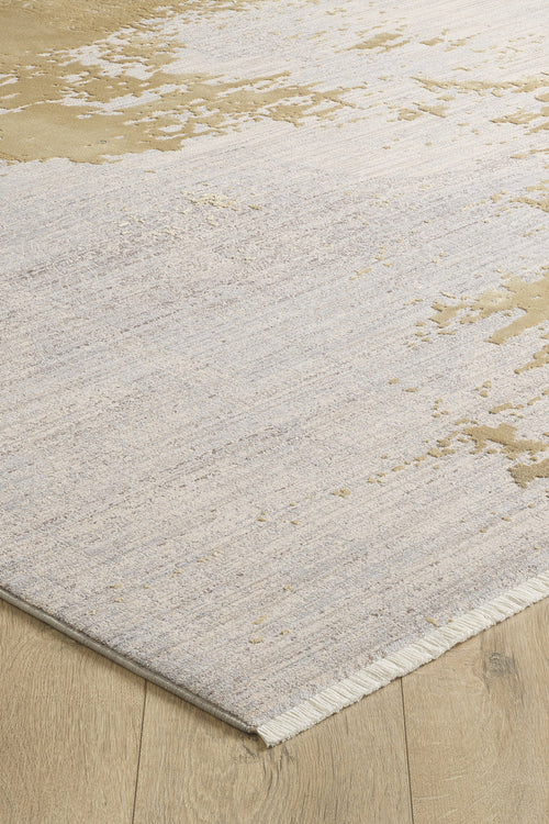 Load image 1 in gallery view. A close-up view of the Old World Elegance Modern Rug - Yellow - M677O, a machine-made rug featuring a neutral abstract pattern in beige and cream with short fringe on one edge, displayed on a light wood floor.