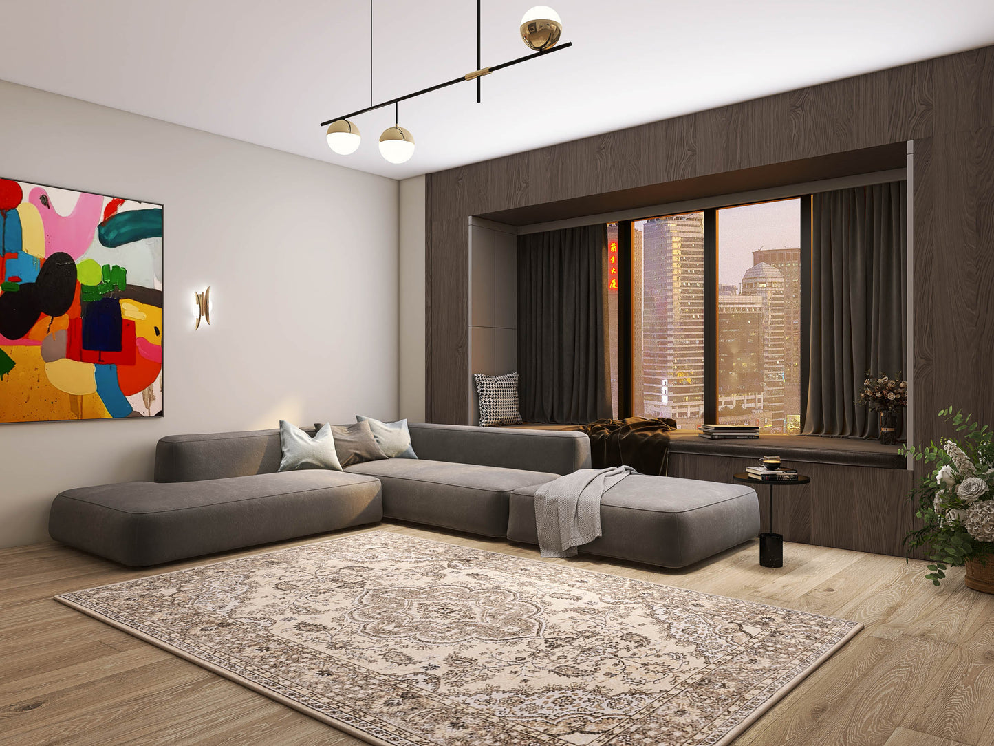 A modern living room featuring a large gray sectional sofa, the Opulent Mirage - Washable Rug - JRN1008 with a subtle medallion design, abstract wall art, floor-to-ceiling city-view window, wooden floors, and a small black side table with flowers.