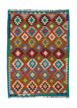 Oriental Harmony - Handwoven Kilim is a colorful flatweave rug with a geometric diamond pattern in red, blue, green, orange, and cream, accented by a teal border and fringed edges. Inspired by traditional kilims for unique style.