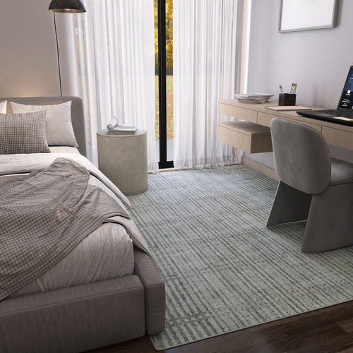 Load image 1 in gallery view. A modern bedroom with a neatly made bed, gray checkered blanket, Ornate Hues - Washable Rug - JRN38 for high-traffic areas, sheer white curtains on tall windows, a floating desk with computer and gray chair. Natural light brightens the space.