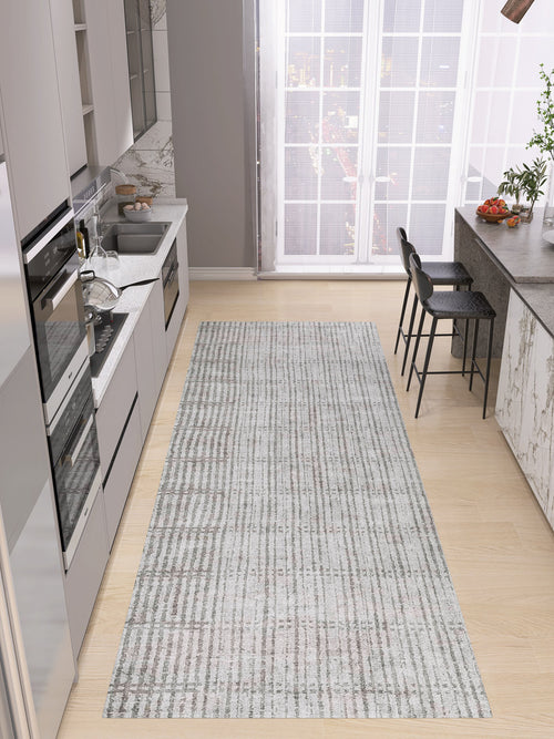 Load image 1 in gallery view. Modern kitchen with light wood flooring, gray cabinets, built-in appliances, marble countertop, two bar stools, and the Ornate Hues - Washable Rug - JRN38—ideal for high-traffic areas. Large windows reveal a stunning cityscape view.