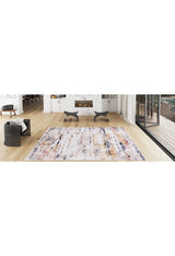Modern living room with light wood floors, a gray armchair, two black stools, a white fireplace, floor-to-ceiling windows to the patio, and a Painted Dreams - Washable Rug - JR432 (Custom Size) in pastel hues ideal for high-traffic areas.