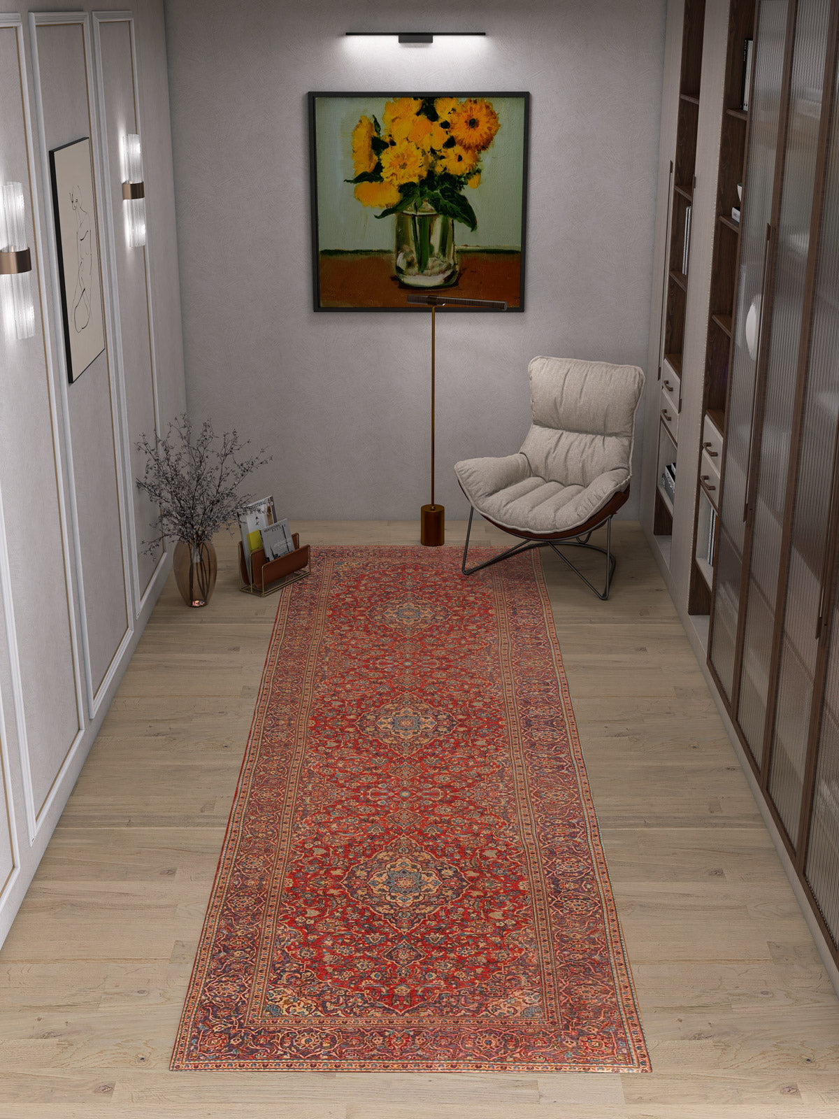 A cozy reading nook with the Palatial Grace - Washable Rug - JRN1021 in red, a modern lounge chair, a small side table topped with a vase, and a yellow flower painting on the wall beneath warm wall lighting.