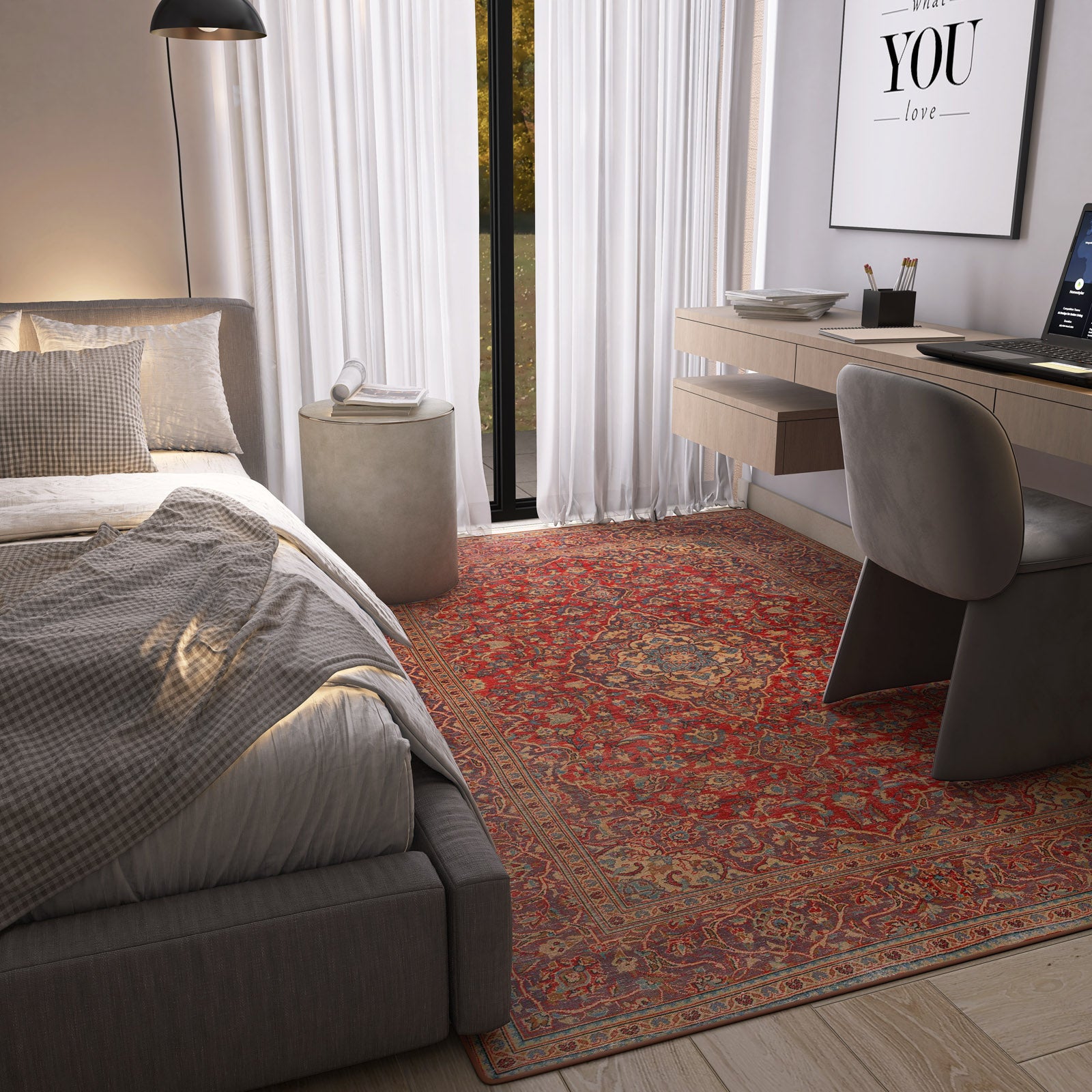Modern bedroom with a bed, desk, and decorative rug.