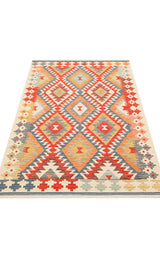 The Pastel Grid - Kilim - NMD09 is a flatwoven bohemian rug with bold geometric diamond patterns in red, orange, yellow, blue, and cream, featuring intricate borders.