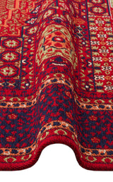 A close-up of the Patch Bloom - Kilim - BHR10 shows its red and dark blue geometric and floral patterns with a visible wave in the fabric near the bottom.