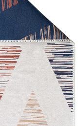 Close-up of the Pattern Field - Washable Double-Sided Kilims - AR38, showing geometric blue, orange, and beige triangular designs with horizontal lines; a folded corner reveals the dark blue underside.