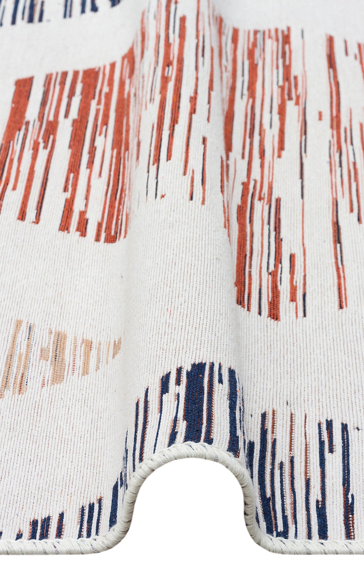 A close-up of Pattern Field - Washable Reversible Kilims - AR38 shows white textured fabric with wavy folds and abstract vertical stripes in red, navy blue, and peach, resembling a flatwoven rug. The curved fabric edge appears in the foreground.