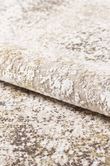A close-up of the Pebble Pathway Premium Area Rug - M683L reveals a soft, plush surface with a textured abstract pattern in beige, cream, and subtle hints of brown and yellow. This machine-made rug combines style with comfort.