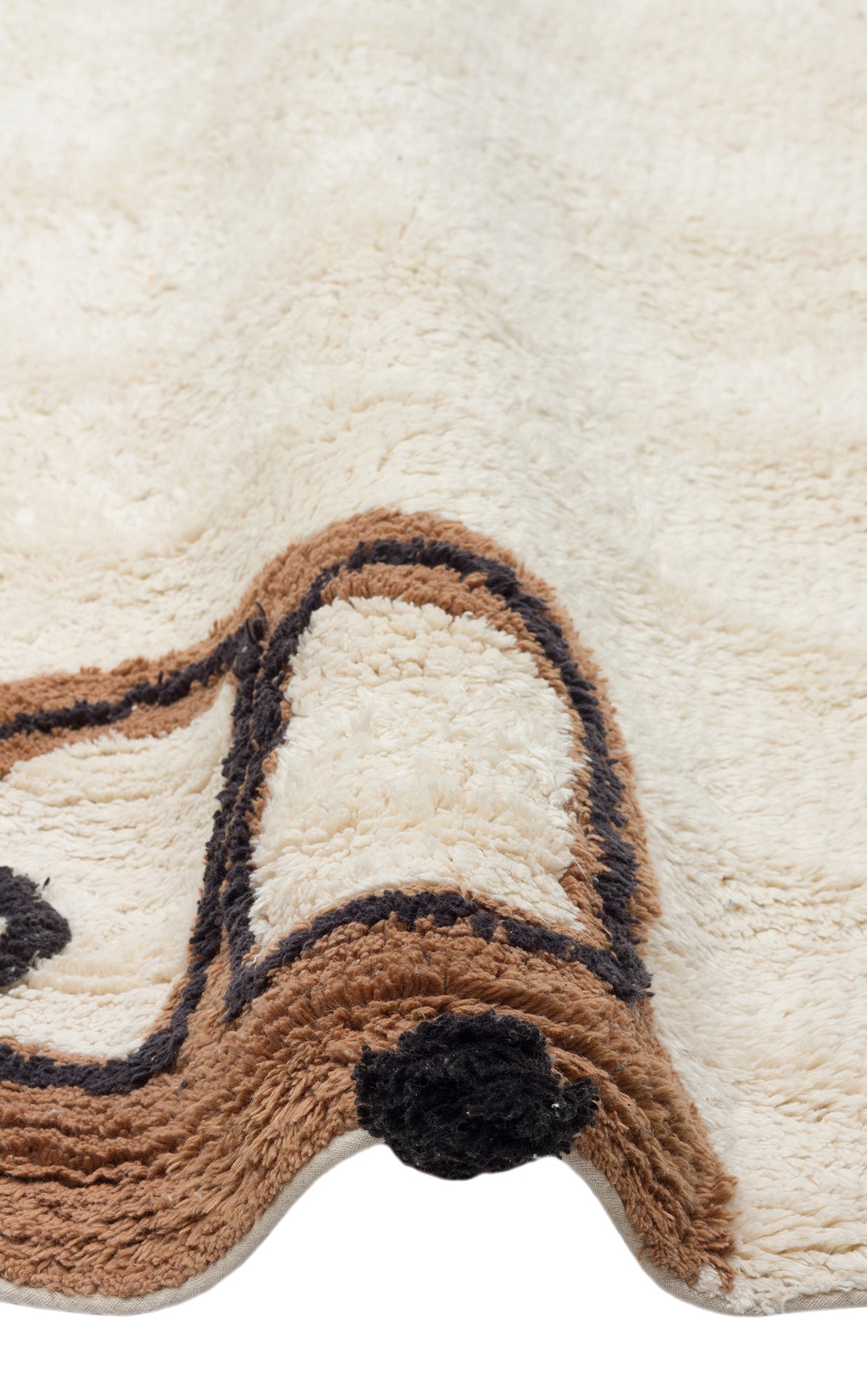 A close-up of the Play Patch - Washable Shaggy - CBN15 rug in cream, featuring a textured surface with brown and black abstract lines. The rug appears soft, has slightly wavy edges, and is machine washable for easy care.
