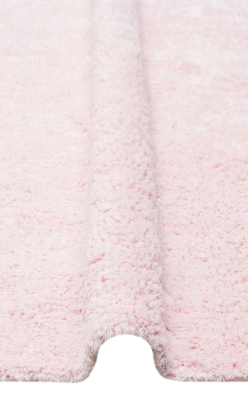 Load image 1 in gallery view. Close-up of the Powder Calm - Washable Shaggy - CBNPLAIN bedroom rug in light pink, featuring a fluffy, textured surface and a raised, folded section running vertically down the center.