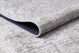 A close-up of the Pure Bliss - Washable Rug - JR745 (Custom Size) in cream and beige, featuring a subtle pattern and lifted edge to reveal its dark, non-slip backing—perfect for allergy-sensitive homes.