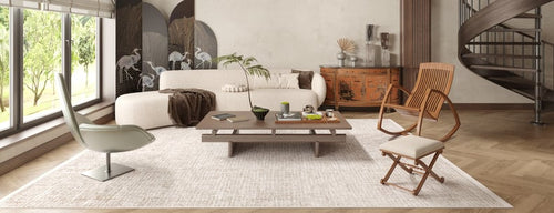 Load image 1 in gallery view. A modern living room with large windows, a white curved sofa, wooden chairs, a low coffee table, the Pure Bliss - Washable Rug - JR745 (Custom Size) for allergy-sensitive comfort, a spiral staircase, and crane-design screens.