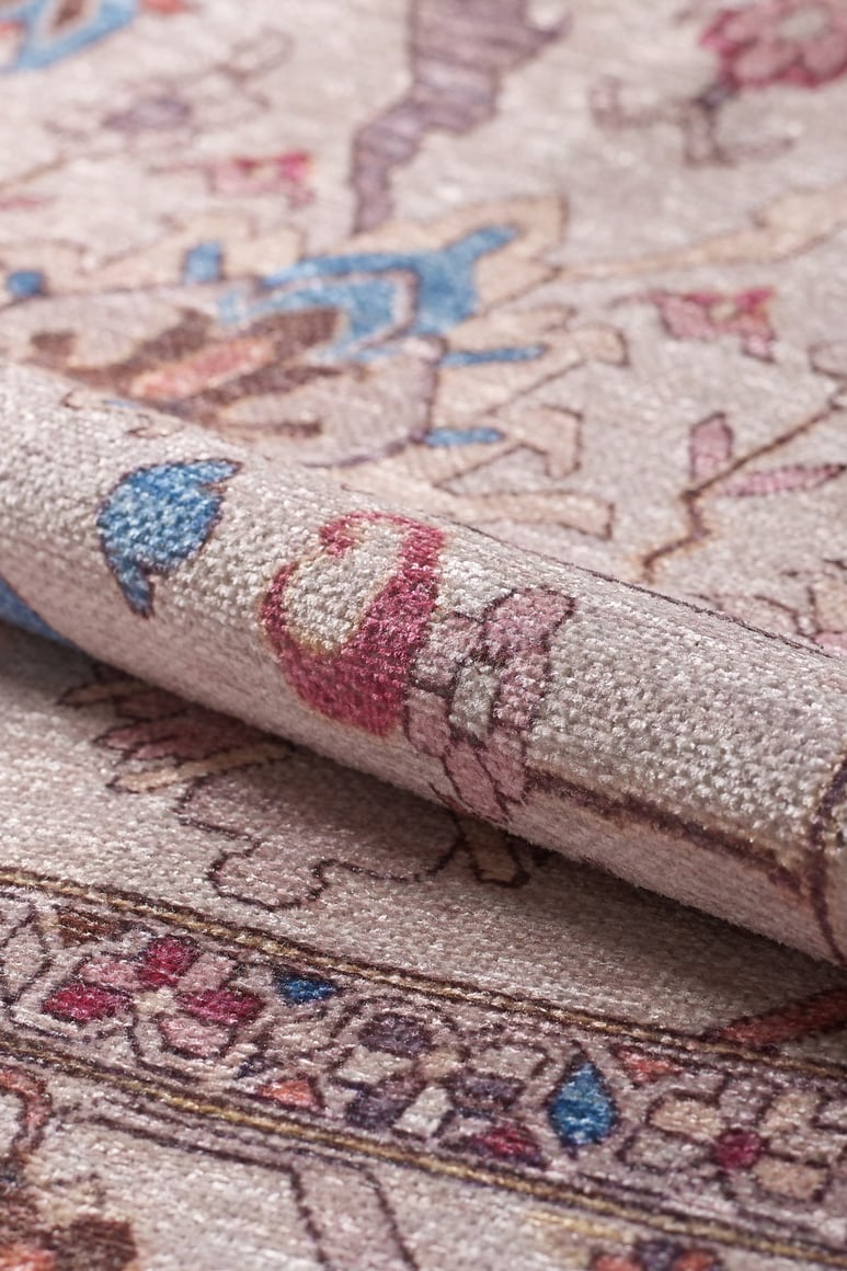 A close-up of the Quasar Traditional Washable Rug - LCC3024 (Custom Size) shows its beige background, colorful blue, red, and pink details, intricate border designs, and visible texture—ideal for high-traffic areas.