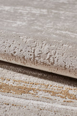 Close-up of the Radiant Edges Bordered Rug - Amber (M542G), showcasing its textured acrylic-viscose fabric, rolled edge, and subtle, intricate surface pattern.